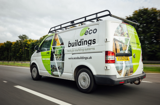 White van driving on road with exciting vehicle graphics